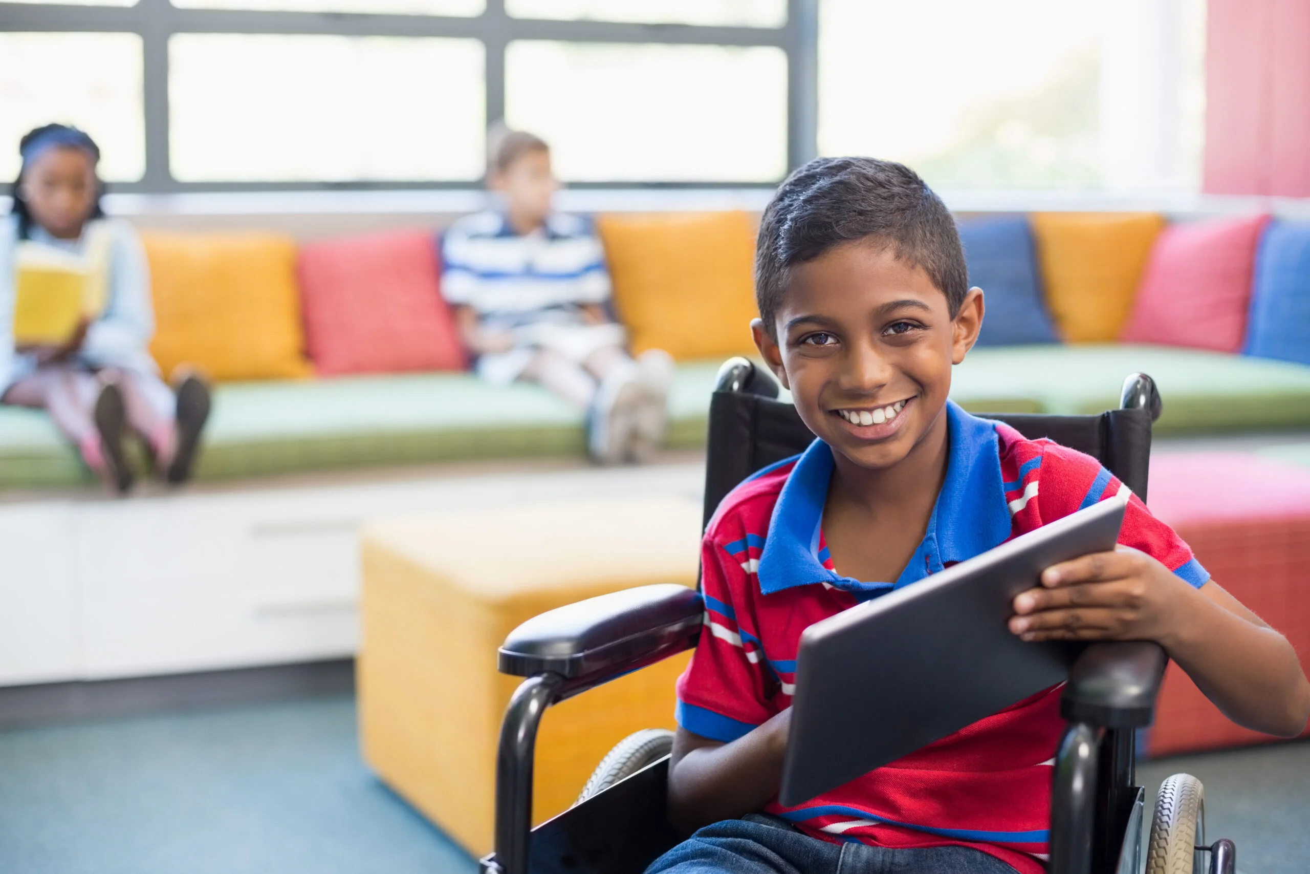 Boy in wheelchair with tablet